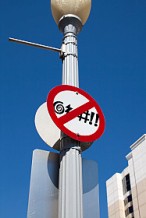 Traffic sign on lamppost showing special characters crossed out