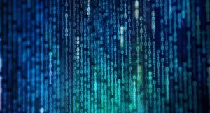 Colourful binary code data on computer monitor