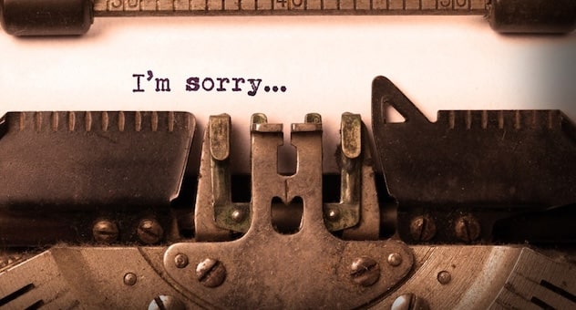 The words 'I'm sorry...' typed on paper in a typewriter