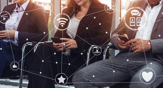 Three businesspeople sitting in chairs looking at their smartphones. Graphics like a WiFi symbol, heart, star, house, and more overlay the photo, indicating the people are using social media on their phones.