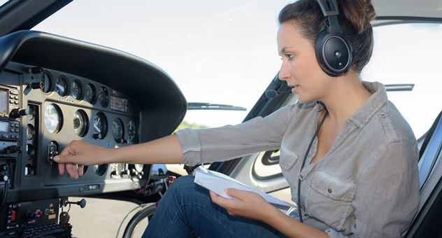 A woman piloting a small plane.