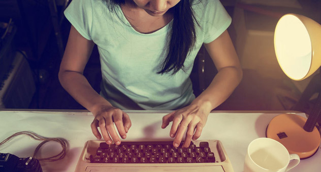 A woman journalist at her typewriter.