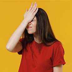 Woman with her hand on her head in exasperation