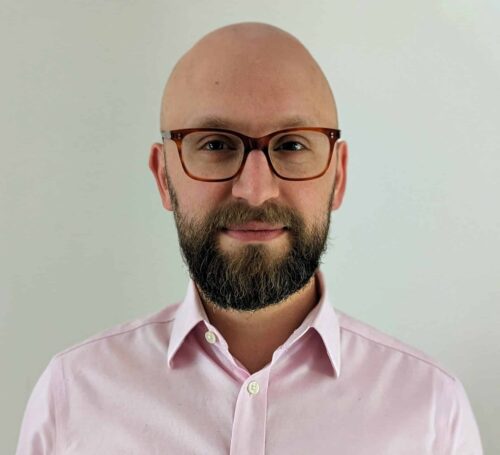 a man with a beard and glasses