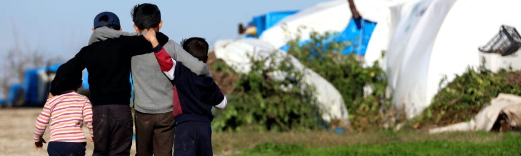 refugee_children_cs Refugee children hug each other in camp